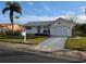 Single-story home with attached garage, driveway, and landscaped lawn at 4415 Great Lakes N Dr, Clearwater, FL 33762