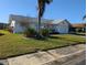 Well-maintained house with a lush lawn and palm tree at 4415 Great Lakes N Dr, Clearwater, FL 33762