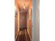 Long hallway with wood floors and artwork at 4415 Great Lakes N Dr, Clearwater, FL 33762