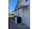 Side of house with AC unit and exterior door at 4415 Great Lakes N Dr, Clearwater, FL 33762