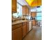 Full view of kitchen with wood cabinets and granite countertops at 4415 Great Lakes N Dr, Clearwater, FL 33762