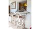 Kitchen features light wood cabinets, granite countertops, and a breakfast bar at 4415 Great Lakes N Dr, Clearwater, FL 33762