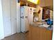 White appliances and wood cabinets in this galley kitchen at 4415 Great Lakes N Dr, Clearwater, FL 33762