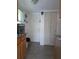 View of kitchen with wood cabinets, tiled floor, and exterior door at 4415 Great Lakes N Dr, Clearwater, FL 33762