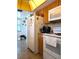 Kitchen with white appliances, wood cabinets, and yellow ceiling at 4415 Great Lakes N Dr, Clearwater, FL 33762