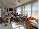 Bright sunroom with ample seating and large windows at 4415 Great Lakes N Dr, Clearwater, FL 33762