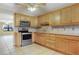 Kitchen boasts oak cabinets, granite countertops, and stainless steel appliances at 4910 Bay Ne St # 109, St Petersburg, FL 33703