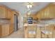 Bright kitchen with oak cabinets, granite countertops, and stainless steel appliances at 4910 Bay Ne St # 109, St Petersburg, FL 33703