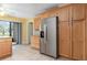 Kitchen features stainless steel refrigerator and oak cabinets at 4910 Bay Ne St # 109, St Petersburg, FL 33703