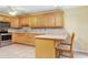 Kitchen with oak cabinets, granite counters, and breakfast bar at 4910 Bay Ne St # 109, St Petersburg, FL 33703