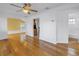 Hardwood floors, ceiling fan, and open concept view of kitchen at 5032 19Th N St, St Petersburg, FL 33714