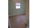 Light teal bedroom with speckled flooring and window at 6012 N Olive Ave, Tampa, FL 33614