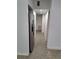 Long hallway with light walls and speckled flooring at 6012 N Olive Ave, Tampa, FL 33614