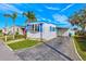 Quaint mobile home boasting a landscaped yard and American flag at 6580 Seminole Blvd # 633, Seminole, FL 33772