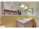 Bathroom with double vanity and yellow tile at 712 Bowsprit Pl, Palm Harbor, FL 34685