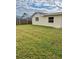 Large grassy backyard with a wooden fence at 7323 Belvedere Ter, New Port Richey, FL 34655