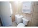 Bathroom with white vanity, toilet, and medicine cabinet at 7323 Belvedere Ter, New Port Richey, FL 34655