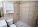 Clean bathroom with shower, grab bar, and white cabinet at 7323 Belvedere Ter, New Port Richey, FL 34655