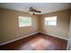 Bright bedroom with two windows and ceiling fan at 7323 Belvedere Ter, New Port Richey, FL 34655