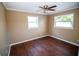 Bedroom with wood-look floors, crown molding, and ceiling fan at 7323 Belvedere Ter, New Port Richey, FL 34655