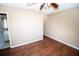 Well-lit bedroom with wood flooring and access to bathroom at 7323 Belvedere Ter, New Port Richey, FL 34655