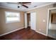 Bedroom with wood-look floors, closet, and ceiling fan at 7323 Belvedere Ter, New Port Richey, FL 34655