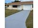 Ranch-style home with a paved driveway and well-maintained lawn at 7323 Belvedere Ter, New Port Richey, FL 34655