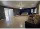 Open concept living room with tiled floors and view into kitchen at 8533 Tidewater Trl, Tampa, FL 33619