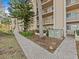 Exterior of building with walkway and landscaping at 90 S Highland Ave # 102, Tarpon Springs, FL 34689