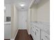 Condo entry with white cabinets and wood flooring at 90 S Highland Ave # 102, Tarpon Springs, FL 34689