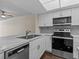Modern kitchen with white cabinets, stainless steel appliances, and marble countertops at 90 S Highland Ave # 102, Tarpon Springs, FL 34689