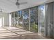 Bright sunroom with sliding doors and view of nature at 90 S Highland Ave # 102, Tarpon Springs, FL 34689