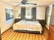 Spacious primary bedroom with large bed, light flooring, and calming wall art at 9790 66Th N St # 312, Pinellas Park, FL 33782