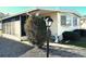 Front view of a mobile home with a lamp post and landscaping at 9790 66Th N St # 312, Pinellas Park, FL 33782