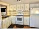 Efficient kitchen featuring white appliances and wood-look flooring at 9790 66Th N St # 312, Pinellas Park, FL 33782