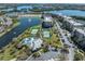 Aerial view of community with lake, tennis courts and buildings at 7069 Key Haven Rd # 504, Seminole, FL 33777