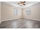 Spacious bedroom with light gray vinyl flooring and ceiling fan at 11201 Mercedes St, Spring Hill, FL 34609