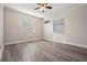 Bright bedroom featuring vinyl flooring and two windows at 11201 Mercedes St, Spring Hill, FL 34609