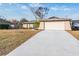 Single-story house with attached garage and landscaped yard at 11201 Mercedes St, Spring Hill, FL 34609
