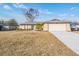 Single-story house with attached garage and landscaped yard at 11201 Mercedes St, Spring Hill, FL 34609