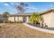 Well-maintained house exterior featuring a walkway and landscaping at 11201 Mercedes St, Spring Hill, FL 34609