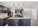 Modern kitchen with dark cabinetry, granite counters, and island at 11201 Mercedes St, Spring Hill, FL 34609