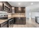 Modern kitchen with dark cabinetry, granite counters, and island at 11201 Mercedes St, Spring Hill, FL 34609