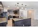 Modern kitchen with dark cabinetry, granite counters, and island at 11201 Mercedes St, Spring Hill, FL 34609