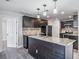 Modern kitchen with dark cabinetry, granite counters, and island at 11201 Mercedes St, Spring Hill, FL 34609