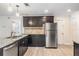 Modern kitchen with dark cabinetry, granite counters, and island at 11201 Mercedes St, Spring Hill, FL 34609