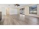 Spacious living room with wood-look floors and sliding glass doors at 11201 Mercedes St, Spring Hill, FL 34609
