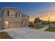 Two-story house with a two-car garage and landscaping at 12001 Ledbury Commons Dr, Gibsonton, FL 33534