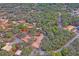Aerial view of property showing house, detached garage, and surrounding land at 12404 Dolquieb Ln, Weeki Wachee, FL 34614