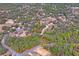 Aerial view of property showing house, detached garage, and surrounding land at 12404 Dolquieb Ln, Weeki Wachee, FL 34614